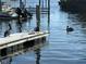 Waterfront scene featuring pelicans on a weathered dock with calm waters and boats, highlighting the peaceful coastal atmosphere at 10315 Cortez W Rd # 12-3, Bradenton, FL 34210