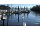 Scenic waterfront view with boats docked and a pelican swimming in calm blue waters, creating a serene coastal setting at 10315 Cortez W Rd # 12-3, Bradenton, FL 34210