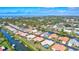 An aerial view shows a waterfront home with a pool and a canal leading out to the bay at 104 Inlets Blvd # 104, Nokomis, FL 34275