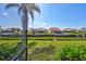 Backyard view of canal, docks, and neighboring homes from screened lanai at 104 Inlets Blvd # 104, Nokomis, FL 34275