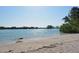 Sandy beach with calm water, perfect for relaxation and enjoying the waterfront views at 104 Inlets Blvd # 104, Nokomis, FL 34275