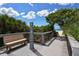 Picturesque view of a boardwalk featuring a bench and shower, leading to a stunning beach at 104 Inlets Blvd # 104, Nokomis, FL 34275