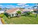 Exterior showcasing a screened-in lanai and lush landscaping, offering an inviting outdoor living space under a bright blue sky at 104 Inlets Blvd # 104, Nokomis, FL 34275