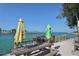 Peaceful waterfront scene with picnic tables and umbrellas, offering a perfect spot for relaxation at 104 Inlets Blvd # 104, Nokomis, FL 34275