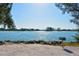 Tranquil waterfront scene with fishing poles and a grill ready for outdoor enjoyment at 104 Inlets Blvd # 104, Nokomis, FL 34275