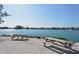 Scenic waterfront with picnic tables overlooking the tranquil water and nearby houses at 104 Inlets Blvd # 104, Nokomis, FL 34275