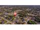 Drone shot displays the home among surrounding residential area, showcasing proximity to greenery and local streets at 1124 Ample Ave, Port Charlotte, FL 33948