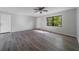 Open living room features wood-look flooring, ceiling fan, and natural light at 1124 Ample Ave, Port Charlotte, FL 33948