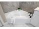 Corner soaking tub in a bathroom with tile floor and a black faucet and fixture at 124 Mark Twain Ln, Rotonda West, FL 33947