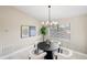 Modern dining area with stylish light fixture and neutral decor at 124 Mark Twain Ln, Rotonda West, FL 33947