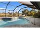 Screened-in pool offers a refreshing escape and scenic backyard views at 124 Mark Twain Ln, Rotonda West, FL 33947