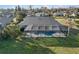 Aerial view of screened in backyard pool with canal view at 124 Mark Twain Ln, Rotonda West, FL 33947