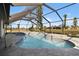 Screened-in pool with a view of the canal at 124 Mark Twain Ln, Rotonda West, FL 33947