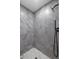 Walk-in shower featuring gray tiling, modern fixtures and hexagonal floor at 124 Mark Twain Ln, Rotonda West, FL 33947