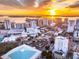 A breathtaking aerial view captures the city skyline meeting the bay during a vibrant sunset at 1335 2Nd St # 402, Sarasota, FL 34236