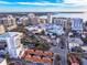 Aerial view of a city featuring a modern building, waterfront, and a mix of residential and commercial properties at 1335 2Nd St # 402, Sarasota, FL 34236