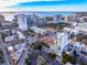 An aerial view shows the white, modern building amongst a scenic cityscape with nearby waterfront at 1335 2Nd St # 402, Sarasota, FL 34236