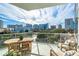 Spacious balcony offers stunning skyline views, perfect for outdoor dining with its charming wooden table set at 1335 2Nd St # 402, Sarasota, FL 34236