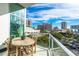 Beautiful balcony with city views, furnished with a wooden table and chairs, ideal for enjoying sunny days at 1335 2Nd St # 402, Sarasota, FL 34236