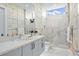 Stunning bathroom featuring modern tiles, a double vanity, and a glass-enclosed shower, offering a luxurious feel at 1335 2Nd St # 402, Sarasota, FL 34236