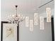 Luxurious lighting featuring both a modern crystal chandelier and square pendant lighting at 1335 2Nd St # 402, Sarasota, FL 34236