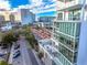 Modern building with a terrace featuring outdoor seating and a jacuzzi with city views at 1335 2Nd St # 402, Sarasota, FL 34236