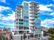 Contemporary condo building with a stylish design, blue glass windows, and private balconies at 1335 2Nd St # 402, Sarasota, FL 34236