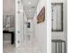 Hallway with marble floors, white walls, and decorative mirrors adding architectural interest at 1335 2Nd St # 402, Sarasota, FL 34236