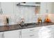 Close-up shot of a modern kitchen with a gas cooktop and decorative backsplash at 1335 2Nd St # 402, Sarasota, FL 34236