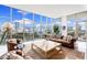 Bright living room boasts floor-to-ceiling windows, offering stunning views of the city skyline and ample natural light at 1335 2Nd St # 402, Sarasota, FL 34236