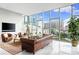 Bright living room with floor-to-ceiling windows showcases stunning city views, creating a luxurious ambiance at 1335 2Nd St # 402, Sarasota, FL 34236