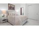 Bright main bedroom showcasing a cozy bed, ambient lighting, and a minimalist aesthetic with marble tile flooring at 1335 2Nd St # 402, Sarasota, FL 34236