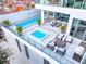 Aerial view of a rooftop pool and hot tub area, perfect for relaxation and entertainment with comfortable lounge seating at 1335 2Nd St # 402, Sarasota, FL 34236