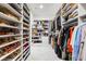 Large walk-in closet features custom shelving for clothing, handbags, shoes, and accessories at 1335 2Nd St # 402, Sarasota, FL 34236