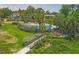 Picturesque aerial view of a lush green landscape featuring pools, wooden walkways, and beautiful tropical foliage at 1617 Brookhouse Dr # 255, Sarasota, FL 34231