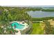 Stunning aerial view showcases a community pool, lush landscaping, and scenic water views at 1617 Brookhouse Dr # 255, Sarasota, FL 34231