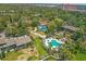 Expansive aerial view featuring a swimming pool, green spaces, and the surrounding neighborhood at 1617 Brookhouse Dr # 255, Sarasota, FL 34231