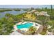 Gorgeous aerial view of a sparkling pool, condos, and tropical foliage near a stunning bay at 1617 Brookhouse Dr # 255, Sarasota, FL 34231