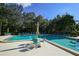 Relaxing community pool area with shaded seating and tropical landscaping at 1617 Brookhouse Dr # 255, Sarasota, FL 34231