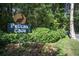 A lovely Pelican Cove community sign amidst lush greenery and colorful flower beds at 1617 Brookhouse Dr # 255, Sarasota, FL 34231