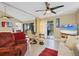 Spacious living room featuring modern ceiling fan, and access to outdoor balcony at 1617 Brookhouse Dr # 255, Sarasota, FL 34231