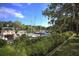 Scenic marina view showcases boats docked along the canal, amidst lush greenery and blue skies at 1617 Brookhouse Dr # 255, Sarasota, FL 34231