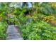 Inviting walkway leading to a gated entrance surrounded by beautiful tropical foliage at 1617 Brookhouse Dr # 255, Sarasota, FL 34231