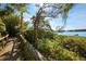 Charming walkway leads to scenic waterfront views, surrounded by lush landscaping and mature trees at 1617 Brookhouse Dr # 255, Sarasota, FL 34231