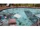 Damaged swimming pool filled with debris in backyard, surrounded by overgrown landscaping and damaged furniture at 1627 Baywinds Ln, Sarasota, FL 34231