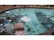 View of a pool with debris floating on the surface and scattered around the pool deck at 1627 Baywinds Ln, Sarasota, FL 34231