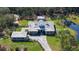 Unique aerial perspective of this estate highlighting the pool, pond and lush landscape at 19610 66Th E Ave, Bradenton, FL 34211