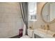 Well-lit bathroom featuring modern sink, toilet, stylish shower, and tiled walls at 19610 66Th E Ave, Bradenton, FL 34211