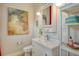 Bathroom featuring a white vanity and a colorful piece of artwork on the wall at 19610 66Th E Ave, Bradenton, FL 34211