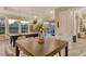 The dining area showcases a dark wood table, a flower centerpiece and backyard view at 19610 66Th E Ave, Bradenton, FL 34211